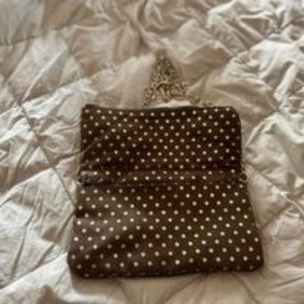 Gold and black cloth purse with long gold chain.